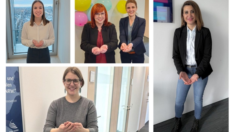 Mitarbeiterinnen der NRW.BANK zeigen die Geste zum Weltfrauentag 2026 unter dem Motto "Give To Gain".