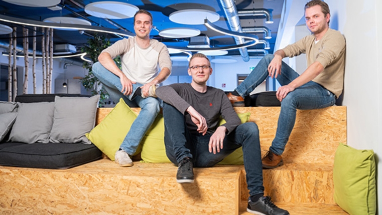 Die drei Gründer der App Tremaze sitzen auf einem Podest.