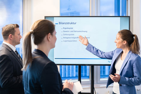 Das Bild zeigt Menschen vor einem Monitor mit dem Wort Bilanzstruktur. Die NRW.BANK unterstützt Unternehmen bei der Verbesserung ihrer Bilanzen.