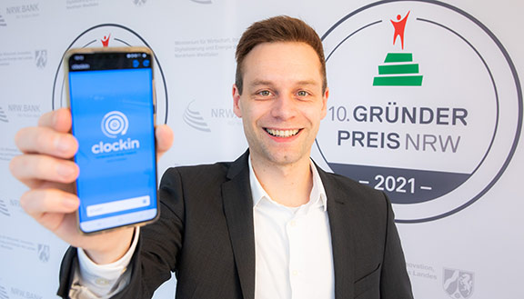 Mitgründer Frederik Neuhaus von clockin präsentiert die App des Unternehmens.